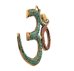 Brass OM wall hanging sculpture, side view with teal gem inlay and red ring detail