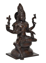 Lord Shiva idol statue, angled view showing detailed face and halo-like headdress, dark brass