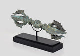 Bronze small Dorje with eight prongs, angled view on black wooden base, turquoise patina