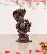 Copper Lakshmi Narasimha figurine, angled view with small attendant figures