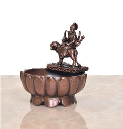Durga Maa urli bowl in copper tone with seated deity statue and ridged outer rim