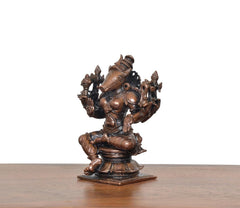 Varahi eight-armed figurine from side view, seated pose, bronze-copper finish