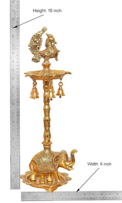 Measuring view: golden peacock diya stand, 19 in tall, 6 in wide, elephant base