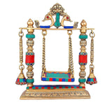 Decorative brass temple swing with Kirtimukha top, jeweled pillar bells
