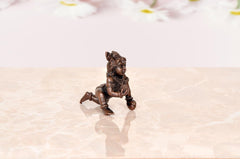 Bal Gopal Krishna idol statue, copper-toned side view of kneeling figure, 2 inch height