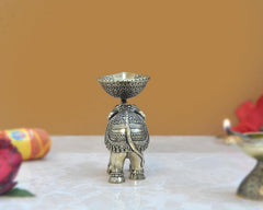 Brass elephant oil lamp diya, back view with patterned body and bowl top