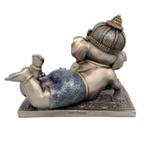 Baby Ganesha resin idol rear/side view, lying pose with raised feet on base