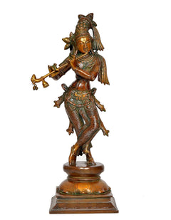 Standing Krishna brass figurine playing flute, detailed headgear, ornate carved base