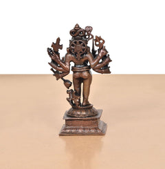 Copper Kal Bhairav idol, rear-angle view with detailed arms and circular emblem on chest