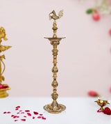 Brass oil lamp diya stand with peacock finial and tiered stem, round base