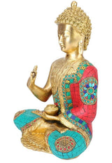 Brass Buddha figurine, side view: gold face, teal/red jeweled robe with patterned chest