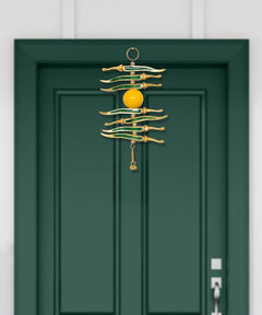 Hanging nimbu mirchi charm with stacked green chillies, central yellow sphere, gold chain tassel
