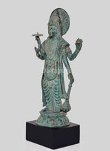 Side view bronze Lord Vishnu idol with circular halo, layered robe, holding a discus