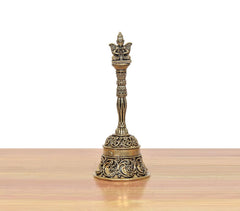 Bronze pooja bell with Garun on top; swirling decorative pattern on the base.