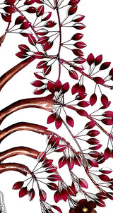 Iron tree wall art close-up with burgundy leaf metalwork and curved branch stems