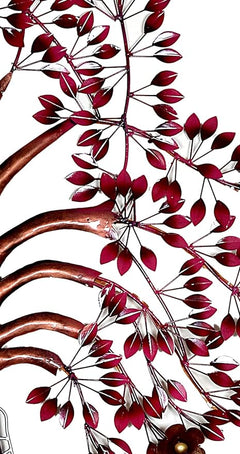 Iron tree wall art close-up with burgundy leaf metalwork and curved branch stems