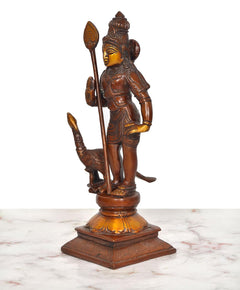 Side view of Karthikeya brass idol standing with tall staff and peacock
