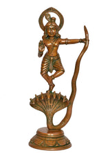 Standing Krishna idol in brass with arched halo, one hand raised, Kaliya cobra