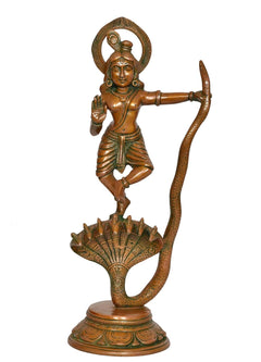 Standing Krishna idol in brass with arched halo, one hand raised, Kaliya cobra