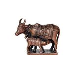 Copper cow pooja mandir figurine with embossed cloth detailing on dark base