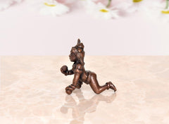 Bal Gopal Krishna idol statue, copper-toned walking pose from rear angle, 2 inch