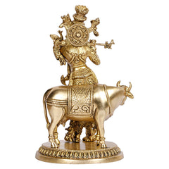 Brass Krishna with cow statue, close view of circular base and saddle pattern