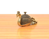 Brass duck-shaped kumkum box with patterned dome lid and curled peacock-side detail
