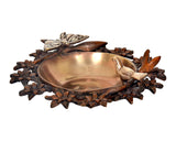 Brass urli bowl side view with butterfly and bird motifs on a textured floral base