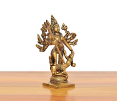 Brass Durga idol angled view, trident and many arms, ornate jewelry, 5 in