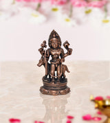 2.5-inch copper Kal Bhairav idol, seated with trident and drum-like ornaments