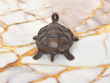 Handcrafted brass tortoise figurine, 1.5 in, top view with raised shell pattern