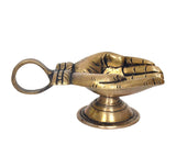 Brass hand-shaped diya oil-wick lamp, side view with handle loop and pedestal