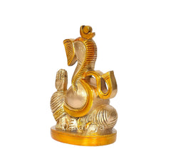Brass Ganesha statue side view, curved trunk, gold crown and raised palm