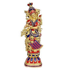 Brass Radha Rani sculpture, seated-style pose with patterned red, blue and gold dress.
