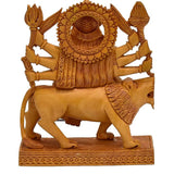 Carved wooden Durga on lion, rear view with textured halo, decorative handicraft idol