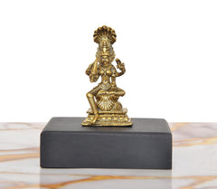 Golden Durga idol statue on dark base, seated pose with raised hands