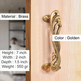 Golden brass peacock door handle pair, mounted on a light wood door