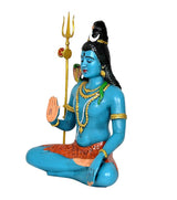 Shiva statue side view, blue seated figure with trident, orange garment details