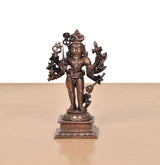 Copper Kal Bhairav standing idol with crown, multiple weapons/arms, mounted on pedestal