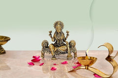 Brass Lakshmi idol, seated blessing pose on pedestal, 4-inch height