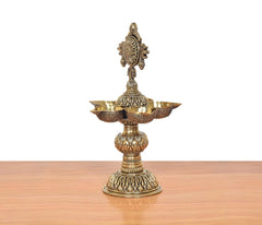Bronze five-diya oil lamp stand, rear view of central finial and bowl holders