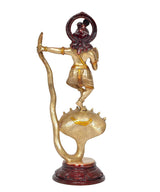 Brass Krishna statue on Kaliya serpent, raised arm and dark red halo details