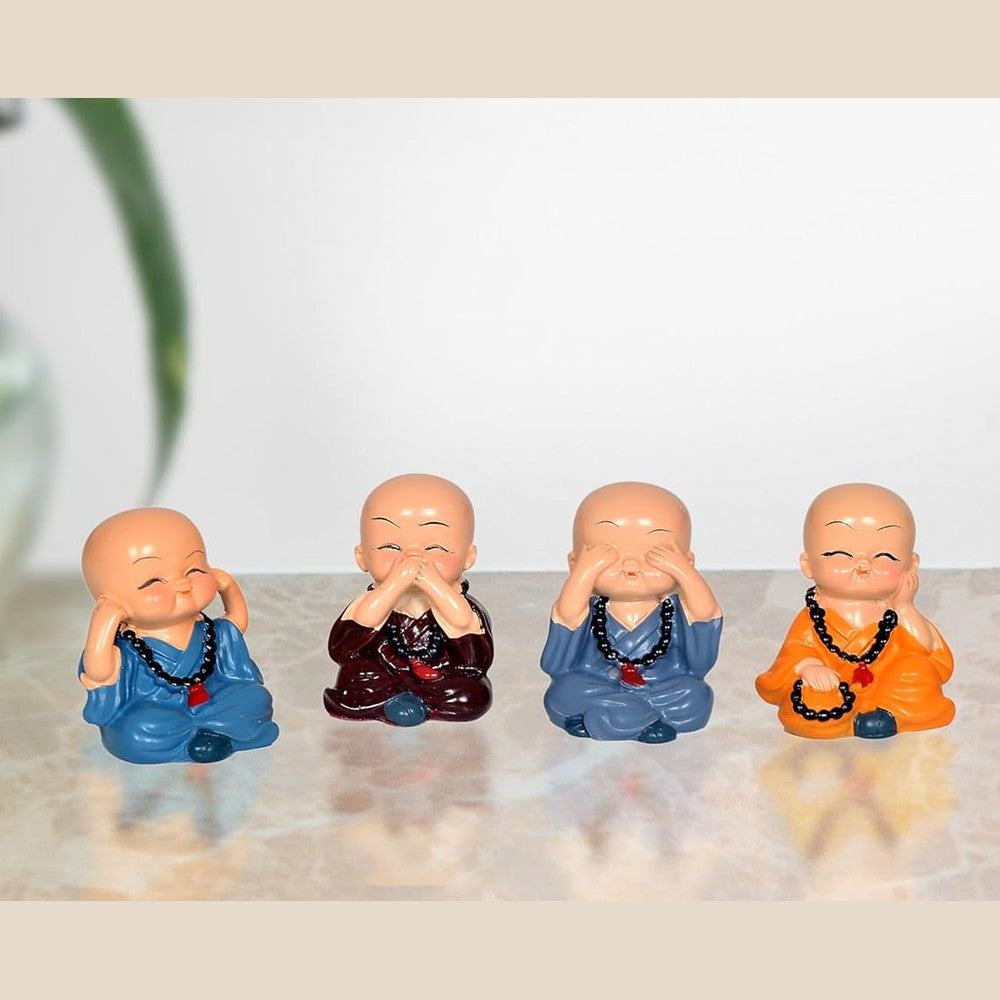 Set of 4 resin smiling Buddha monk figurines, seated poses in blue and orange robes