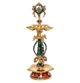 Front view brass chakra oil lamp diya, painted green-red deity with three bowl tops