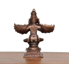 Copper Garun Bhagwan idol, rear view, broad wings, seated form on pedestal