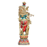 Kishan Murti brass sculpture, back view with spiral halo and patterned red/teal garments