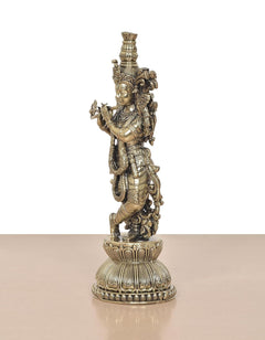 Lord Krishna brass sculpture playing flute, side view with ornate layered base