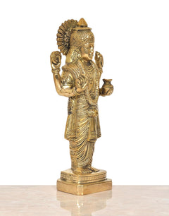 Brass deity statue, angled view of standing four-armed figure with ornate crown and base