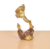 Ganesha brass idol in low seated pose, meenakari motifs on crown and arms