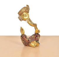 Ganesha brass idol in low seated pose, meenakari motifs on crown and arms